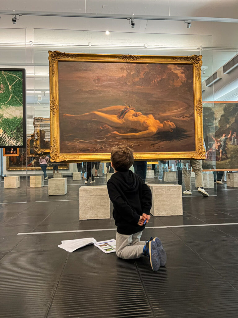Criança de 5 anos observando obra no MASP durante atividade de caça aos detalhes - Visita ao MASP com Crianças